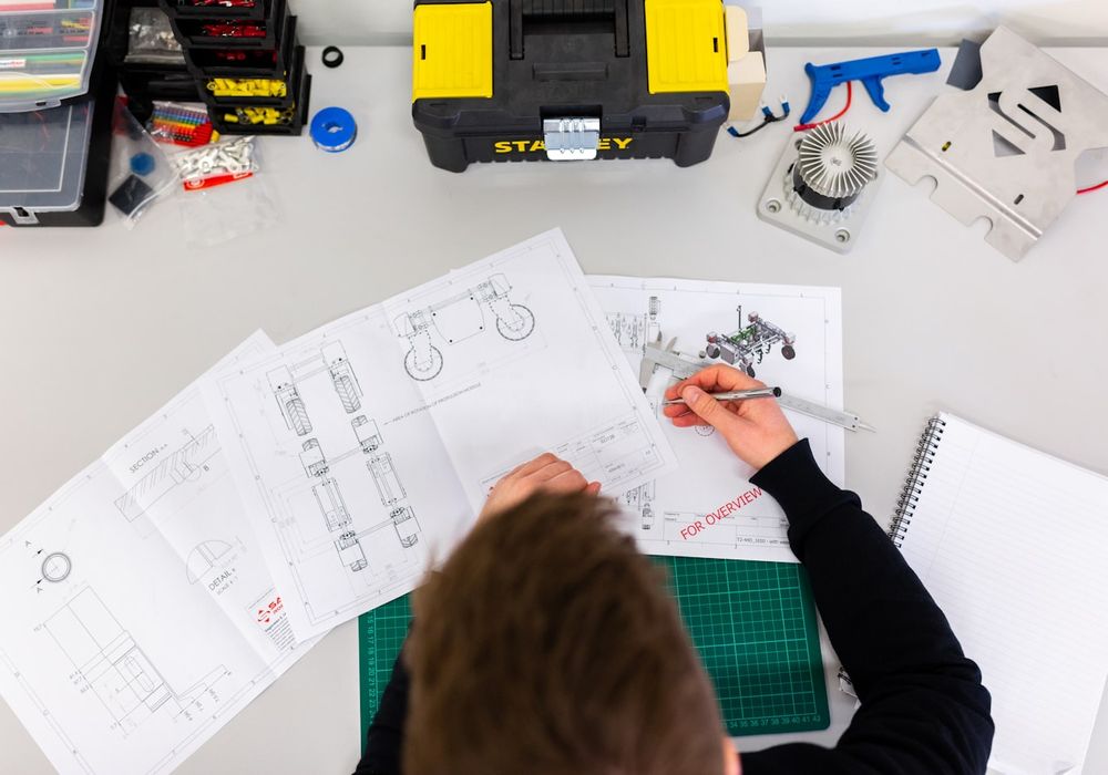 Architectural drawings and tools laid out during project planning