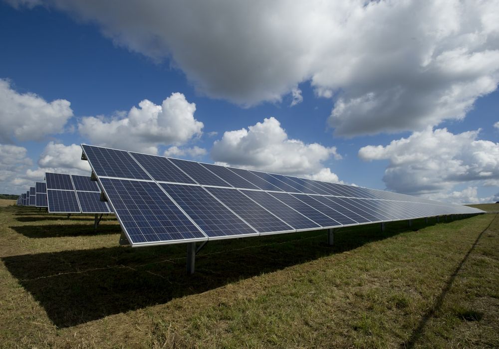 A ground-mounted solar array under an open sky